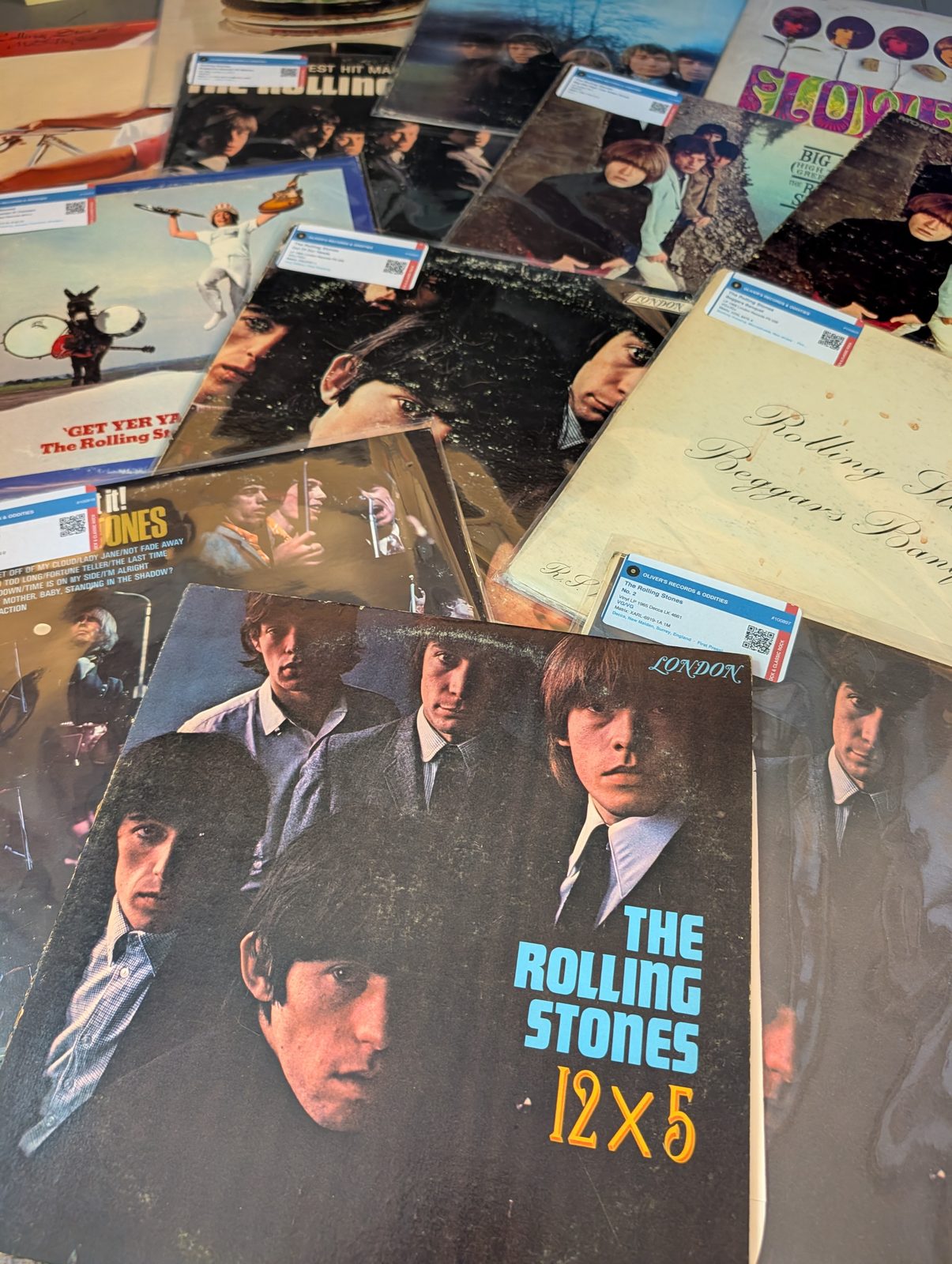 Rolling Stones records fanned out — 12x5 in front, Beggars Banquet, Flowers, Get Yer Ya-Ya's Out visible behind